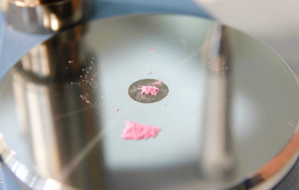 A tusi sample being checked on a spectrometer at a drug checking clinic.